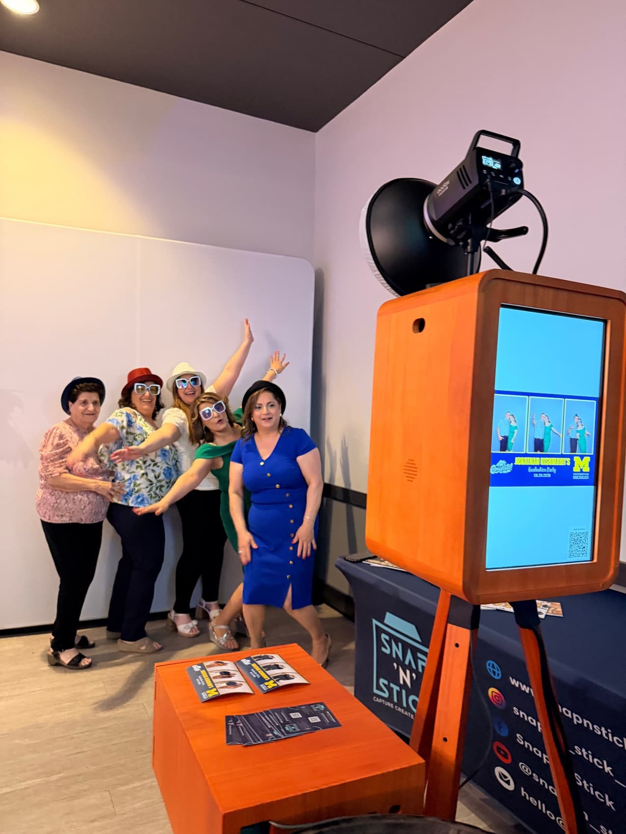 Guests posing at the Snap'N'Stick photo booth in Michigan